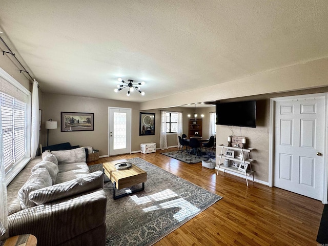 living room with wood-type flooring and a textured ceiling