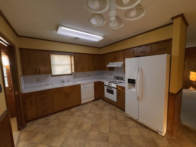 kitchen featuring white appliances, ornamental molding, sink, and a textured ceiling