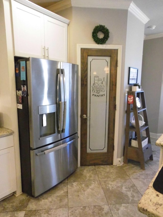 kitchen featuring white cabinetry, stainless steel fridge with ice dispenser, crown molding, and light stone countertops