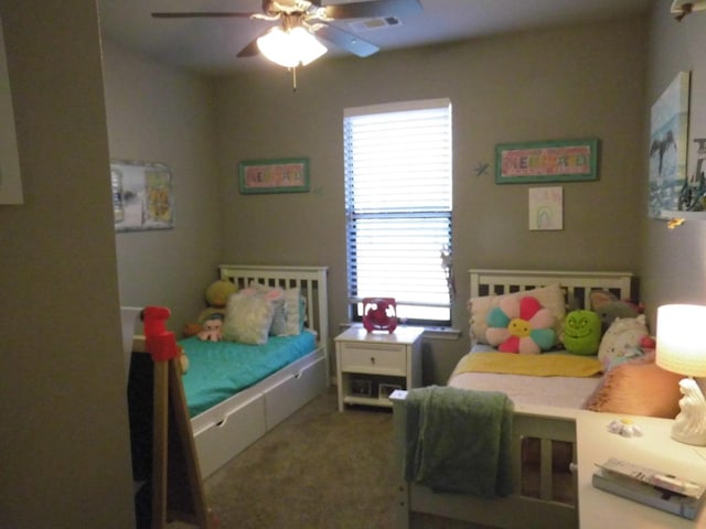 bedroom featuring ceiling fan and carpet