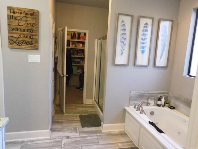 bathroom featuring vanity and separate shower and tub