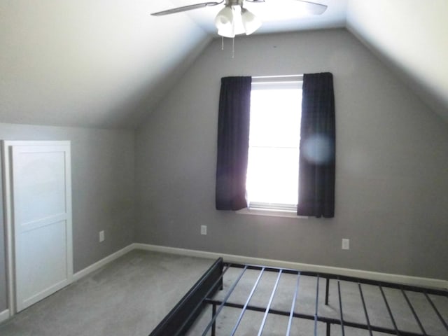 additional living space with ceiling fan, lofted ceiling, carpet floors, and plenty of natural light