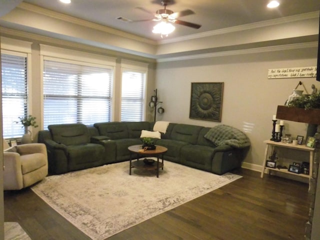 living room with ornamental molding, dark wood-type flooring, and ceiling fan