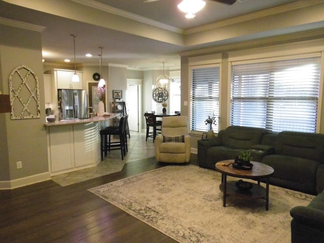 living room with crown molding, dark hardwood / wood-style floors, and ceiling fan