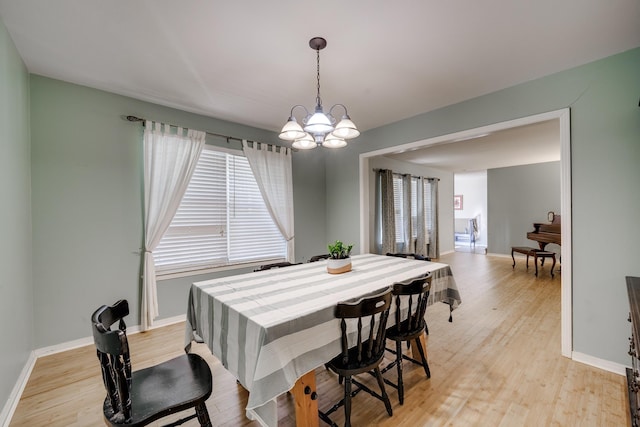 dining room featuring an inviting chandelier and light hardwood / wood-style floors