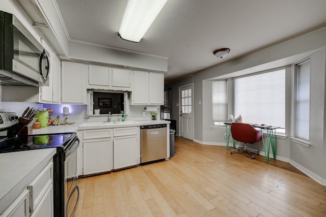 kitchen featuring sink, stainless steel appliances, light hardwood / wood-style floors, and white cabinets