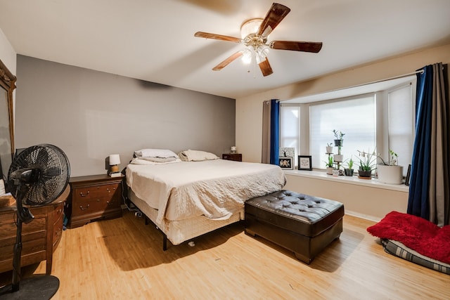 bedroom featuring light wood-type flooring and ceiling fan