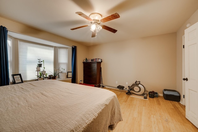 bedroom with light wood-type flooring and ceiling fan