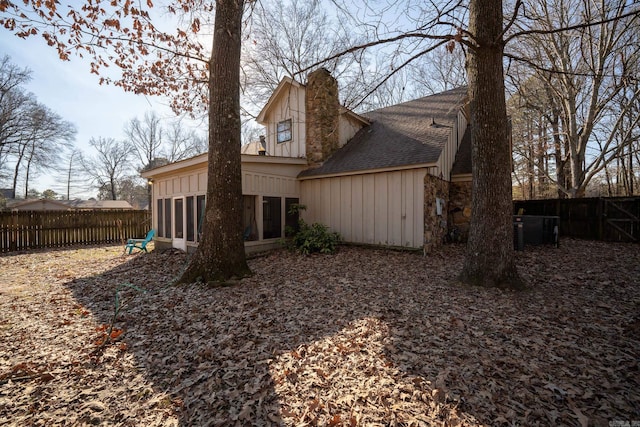 rear view of property featuring a sunroom