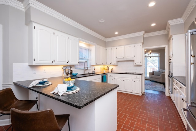 kitchen with white cabinetry, kitchen peninsula, and tasteful backsplash