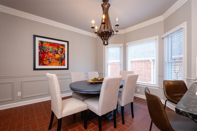 dining room featuring a notable chandelier and ornamental molding