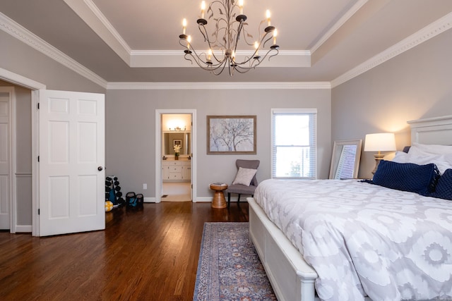 bedroom featuring a raised ceiling, crown molding, dark hardwood / wood-style floors, and connected bathroom