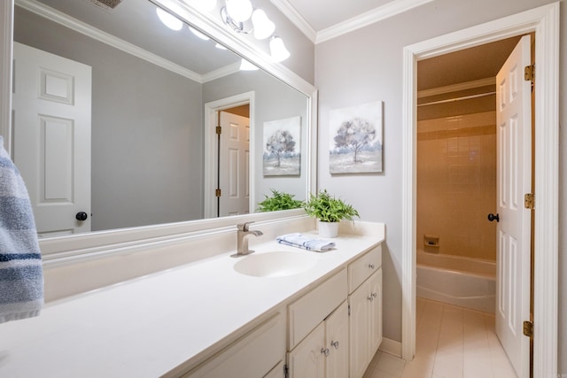 bathroom with ornamental molding, vanity, tile patterned floors, and tiled shower / bath