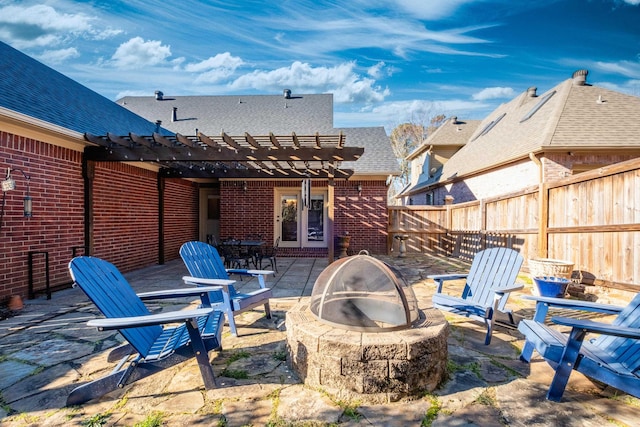 view of patio with a pergola and a fire pit