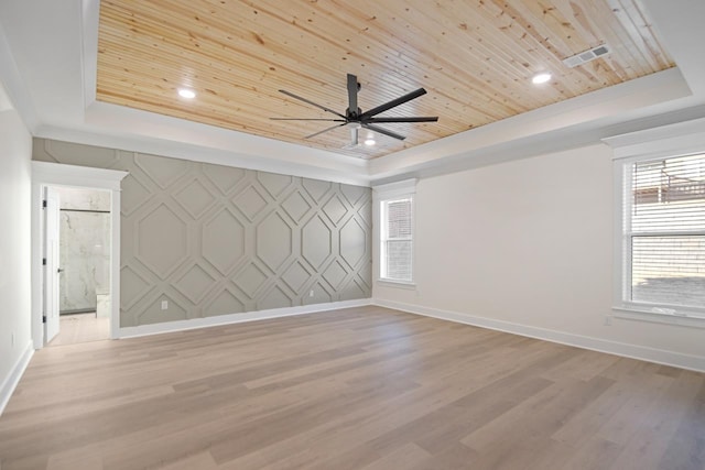 spare room with light hardwood / wood-style flooring, wooden ceiling, and a tray ceiling