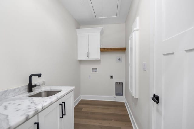 laundry area featuring dark wood-type flooring, sink, cabinets, hookup for a washing machine, and electric dryer hookup