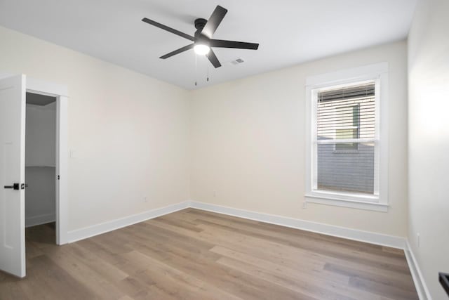 empty room featuring ceiling fan and light hardwood / wood-style flooring