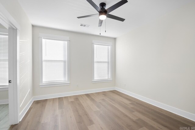 empty room featuring ceiling fan and light hardwood / wood-style floors