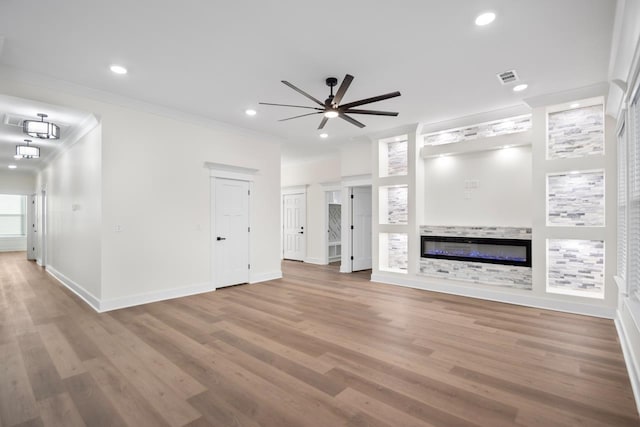 unfurnished living room with hardwood / wood-style flooring, ceiling fan, crown molding, and built in features