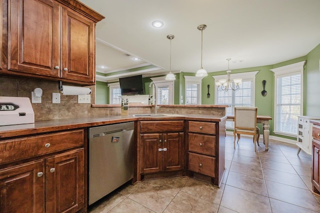 kitchen featuring pendant lighting, dishwasher, a raised ceiling, light tile patterned flooring, and kitchen peninsula