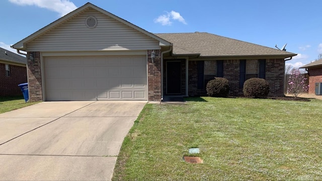 ranch-style home featuring a garage, a front lawn, and central air condition unit