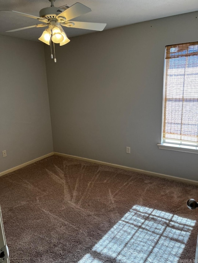 carpeted empty room with ceiling fan