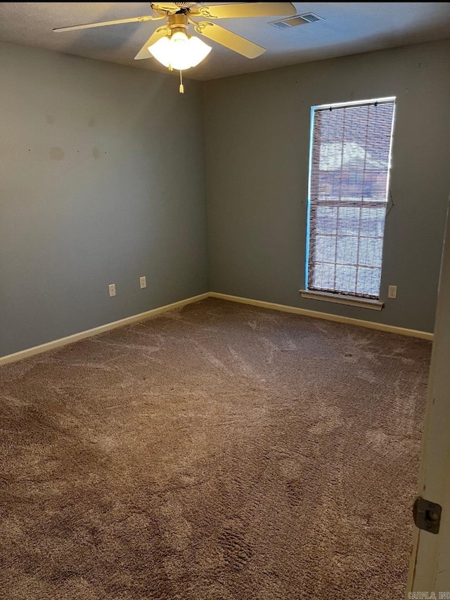 carpeted empty room featuring ceiling fan