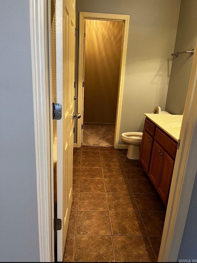 bathroom featuring vanity and toilet