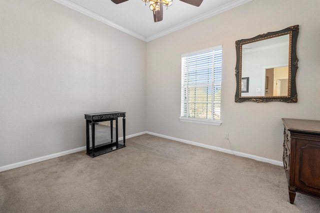 carpeted empty room with ornamental molding and ceiling fan