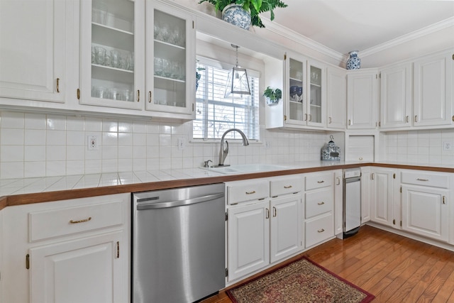 kitchen with sink, stainless steel dishwasher, white cabinets, and decorative backsplash