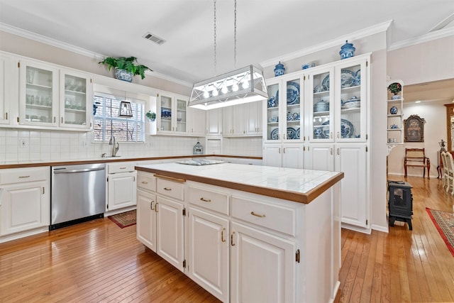 kitchen featuring white cabinets, decorative light fixtures, a center island, and dishwasher