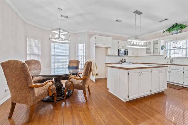 kitchen featuring white cabinetry, pendant lighting, and a center island