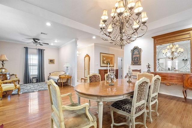 dining room featuring crown molding, ceiling fan with notable chandelier, and light hardwood / wood-style flooring