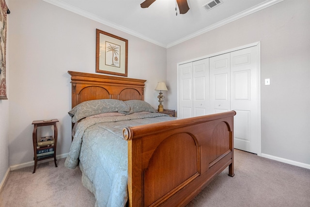 carpeted bedroom with crown molding, ceiling fan, and a closet