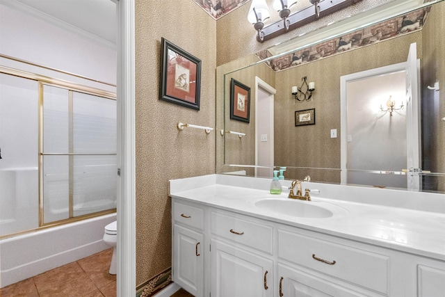 full bathroom featuring combined bath / shower with glass door, tile patterned flooring, vanity, ornamental molding, and toilet