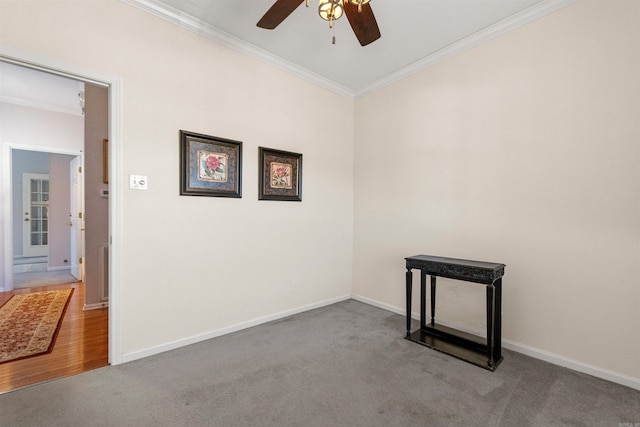 carpeted empty room featuring ornamental molding and ceiling fan