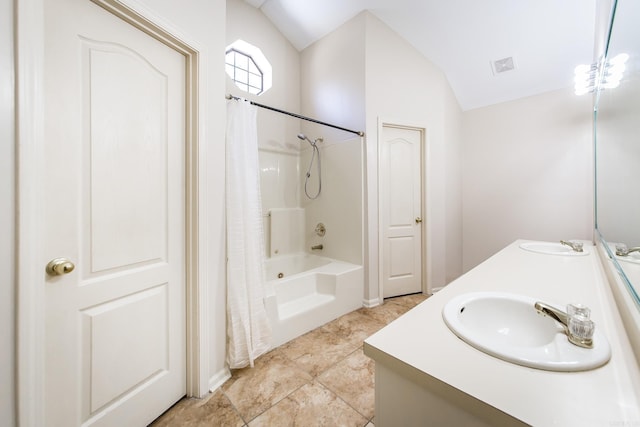 bathroom with lofted ceiling, vanity, and shower / bath combo