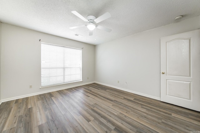 unfurnished room with dark hardwood / wood-style flooring, ceiling fan, and a textured ceiling