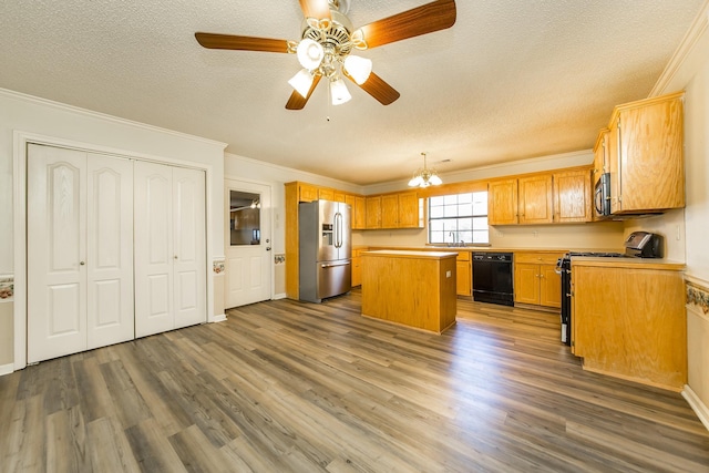 kitchen featuring a kitchen island, dishwasher, stainless steel fridge, gas stove, and a textured ceiling