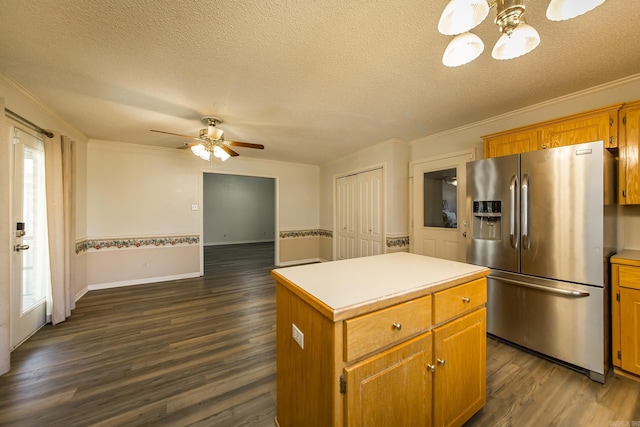 kitchen featuring dark wood-type flooring, crown molding, stainless steel fridge with ice dispenser, a textured ceiling, and a kitchen island