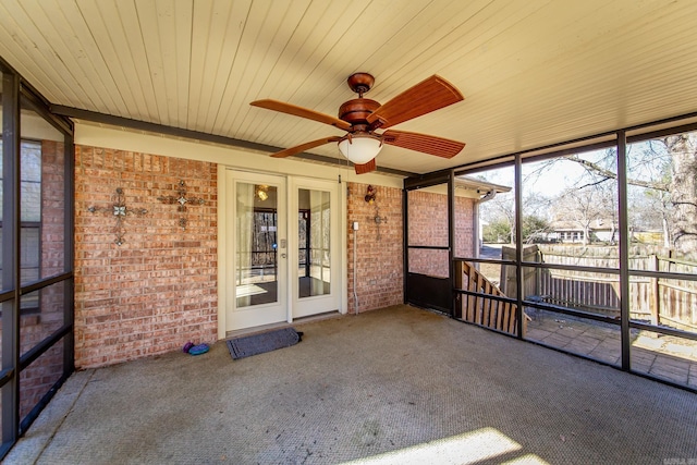 unfurnished sunroom featuring ceiling fan