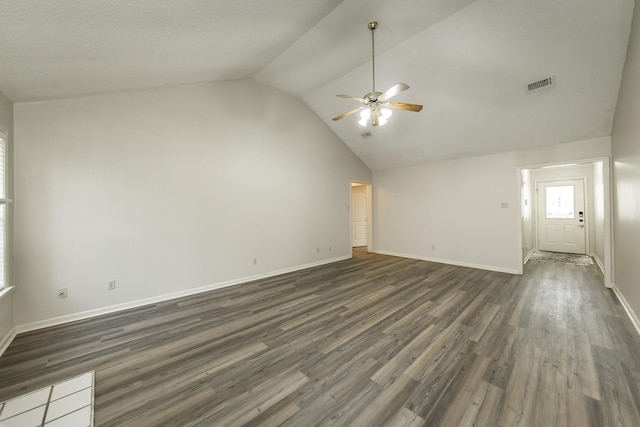 unfurnished living room with ceiling fan, lofted ceiling, and dark hardwood / wood-style flooring