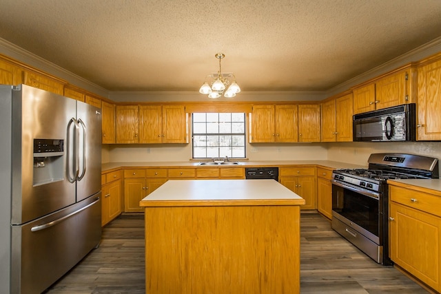 kitchen featuring sink, crown molding, black appliances, a kitchen island, and decorative light fixtures