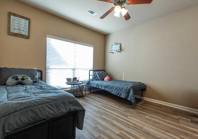 bedroom with hardwood / wood-style flooring, lofted ceiling, and ceiling fan