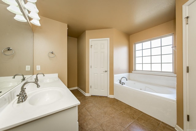 bathroom featuring tile patterned flooring, vanity, a tub, and an inviting chandelier