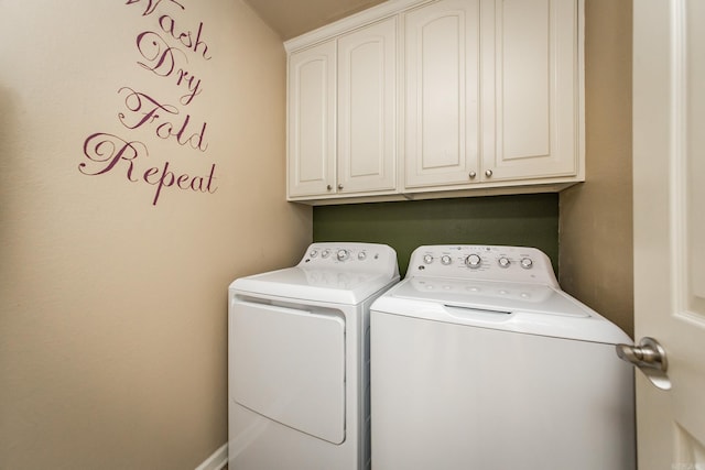 laundry room featuring cabinets and washing machine and clothes dryer