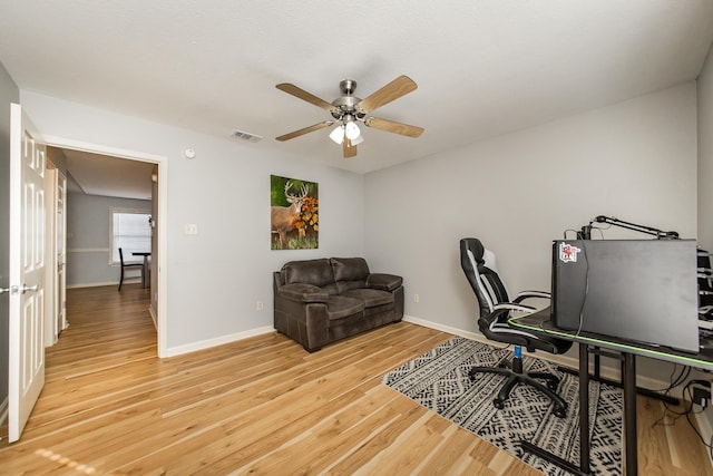 office space featuring ceiling fan and light hardwood / wood-style flooring