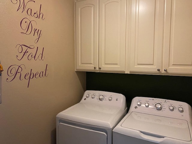 washroom with cabinets and washing machine and clothes dryer