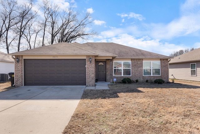 ranch-style home with a garage and central air condition unit