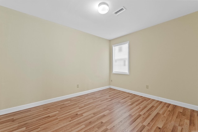 spare room featuring light wood-type flooring